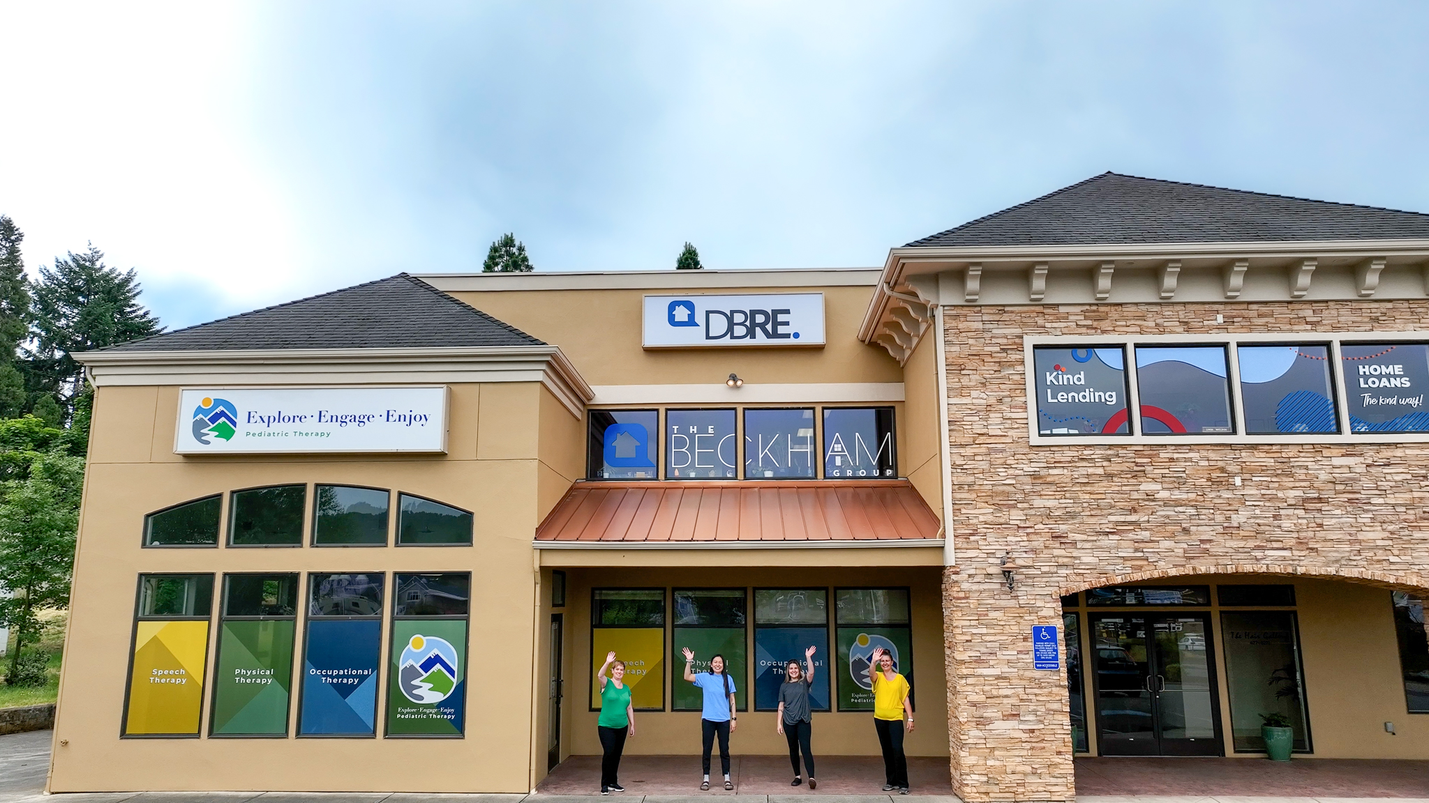 Explore Engage Enjoy Employees Waving Outside Of Building