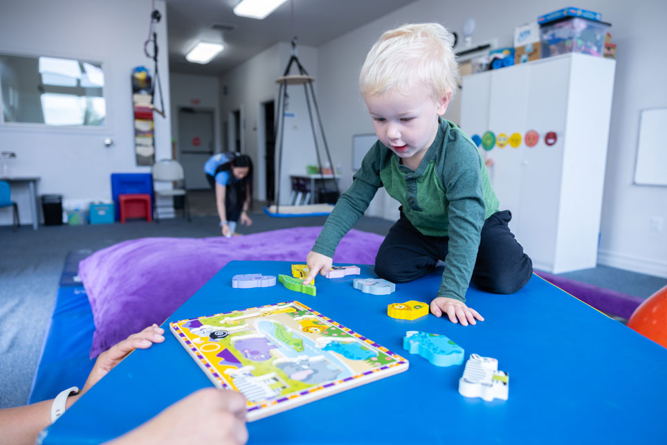 clinical space theraputic space bright playroom toddler boy pointing to crocodile occupational therapy physical therapy roseburg oregon explore engage enjoy pediatric therapy