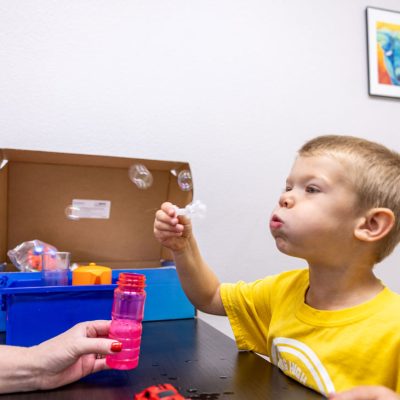 pediatric-speech-therapy-pediatric-therapy-child-blowing-bubbles-pediatric-therapy-office-speech-therapy-exercises-explore-engage-enjoy-roseburg-oregon