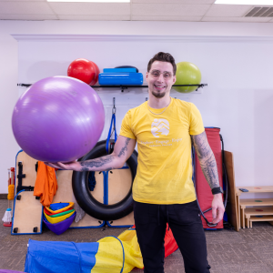 Jeremy-zibull-COTA-L-Therapy-Assistant-Occcupational-therapy-holding-purple-ball-in-right-hand-e3-Roseburg-oregon-douglas-county Jeremy-zibull-COTA-L-Therapy-Assistant-Occcupational-therapy-holding-purple-ball-in-right-hand-e3-Roseburg-oregon-douglas-county