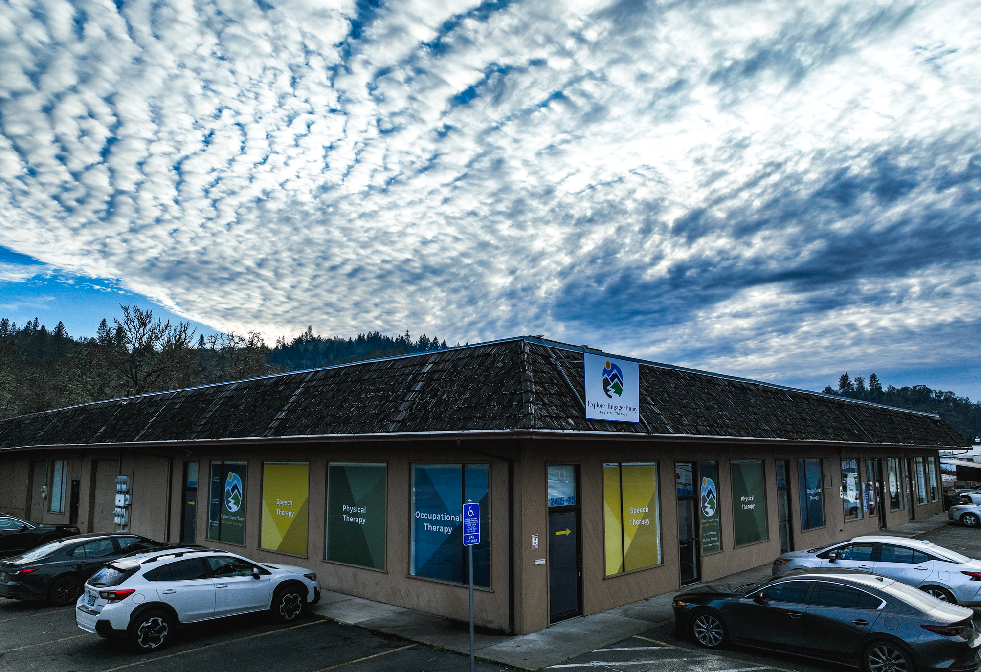 Explore Engage Enjoy Employees Waving Outside Of Building